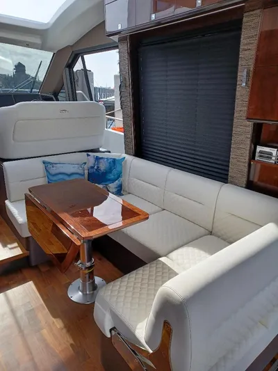 Must Sell, Make An Offer Yacht Photos Pics Interior of 2022 Galeon 410 HTC yacht with elegant seating and wooden table.