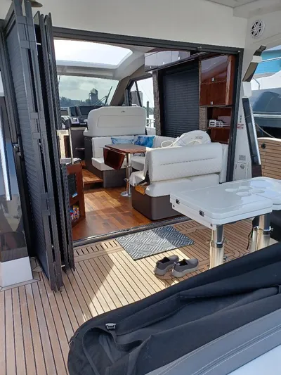 Must Sell, Make An Offer Yacht Photos Pics 2022 Galeon 410 HTC yacht interior with modern seating and wooden flooring.
