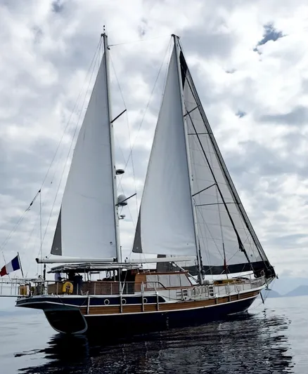 Hama Yacht Photos Pics Custom 1994 ABATS Gulet Ketch sailing on calm waters under cloudy skies.