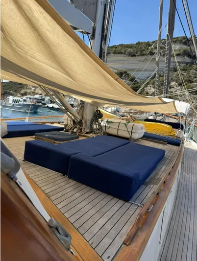 Hama Yacht Photos Pics Luxurious 1994 Custom ABATS GULET KETCH yacht deck with blue cushions and sunshade.