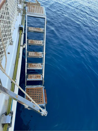 Hama Yacht Photos Pics Boarding ladder of 1994 Custom ABATS Gulet Ketch over clear blue water.