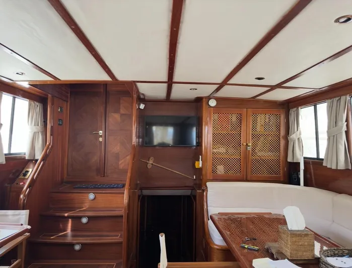 Hama Yacht Photos Pics Interior of 1994 Custom ABATS Gulet Ketch with wooden decor and seating area.