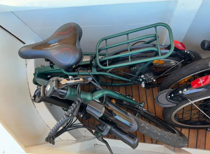Hama Yacht Photos Pics Folded bicycle stored on a wooden deck, featuring a comfortable seat and sturdy frame.