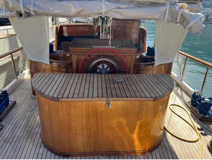Hama Yacht Photos Pics Wooden deck of 1994 Custom ABATS GULET KETCH with steering wheel and seating area.