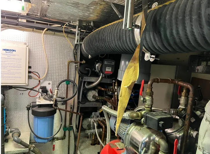 Hama Yacht Photos Pics Engine room of 1994 Custom ABATS Gulet Ketch with pipes, valves, and equipment.