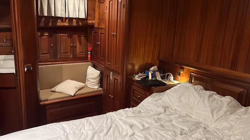 Hama Yacht Photos Pics Luxurious wooden cabin interior of 1994 Custom ABATS Gulet Ketch with bed and seating area.