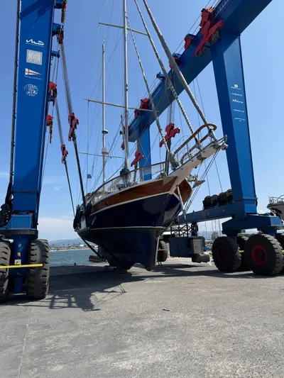 Hama Yacht Photos Pics 1994 Custom ABATS GULET KETCH sailboat lifted by blue crane at dockside.
