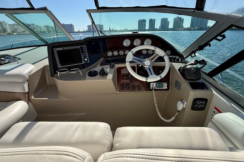 Island Time II Yacht Photos Pics Helm of 2005 Four Winns 378 Vista yacht with city skyline view.