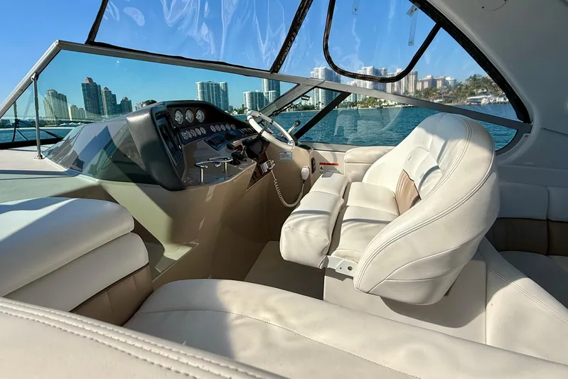 Island Time II Yacht Photos Pics 2005 Four Winns 378 Vista yacht interior with white leather seating and city skyline view.