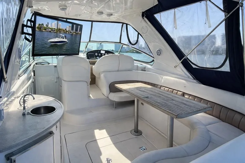Island Time II Yacht Photos Pics Luxurious interior of 2005 Four Winns 378 Vista yacht with seating and TV.