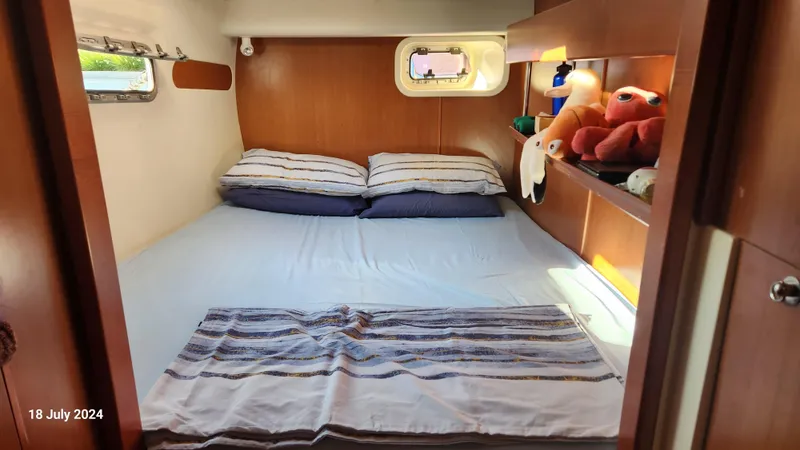  Yacht Photos Pics Cozy cabin bedroom in a 2007 Leopard 40 catamaran with plush toys and striped bedding.