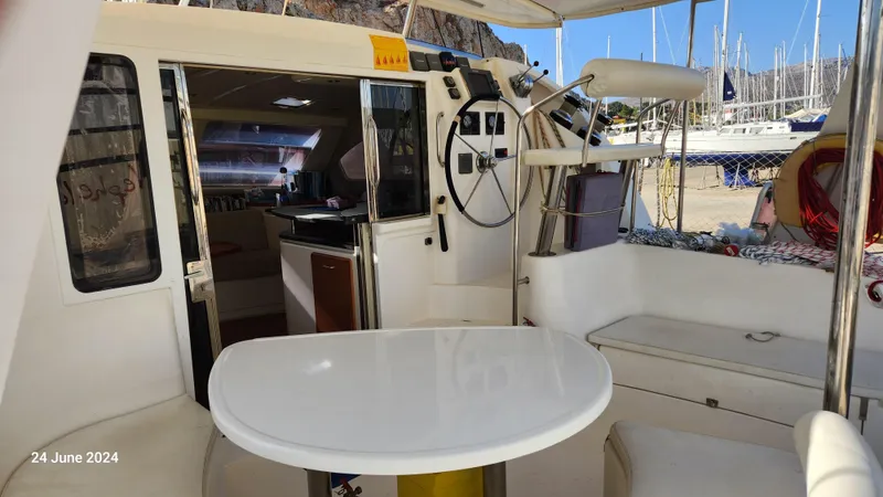  Yacht Photos Pics Leopard 40 catamaran interior, 2007 model, featuring cockpit seating and helm, docked at marina.