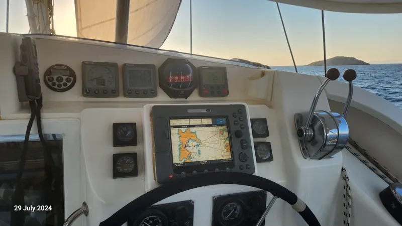  Yacht Photos Pics Sailing yacht cockpit with navigation equipment, Leopard 40, 2007 model, at sea during sunset.