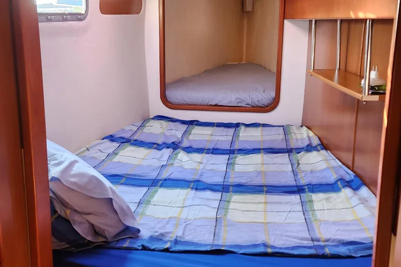 Yacht Photos Pics Cozy cabin interior of 2007 Leopard 40 catamaran with plaid bedding.