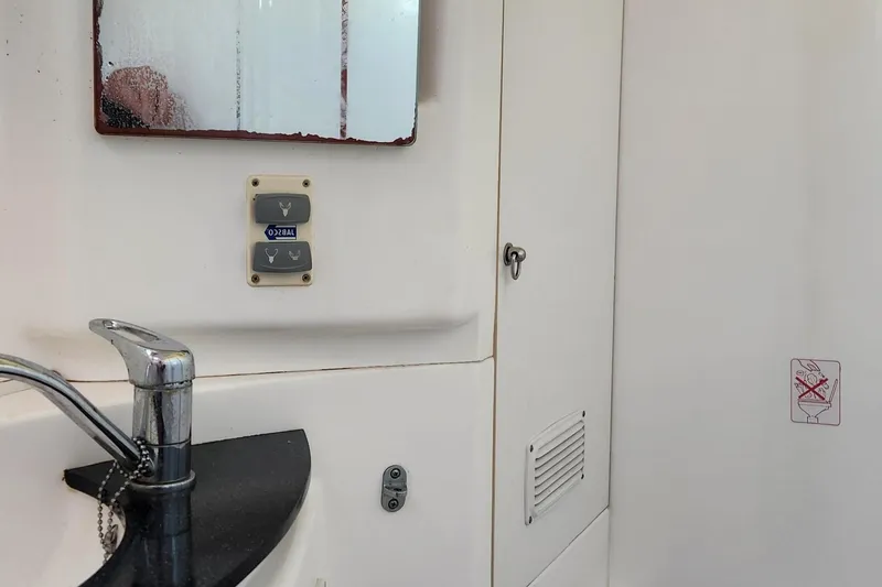  Yacht Photos Pics Interior of 2007 Leopard 40 yacht bathroom with sink, mirror, and storage cabinet.