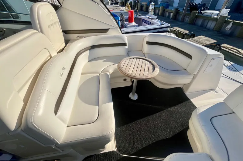  Yacht Photos Pics 2007 Sea Ray 38 Sundancer yacht interior with white seating and wooden table.