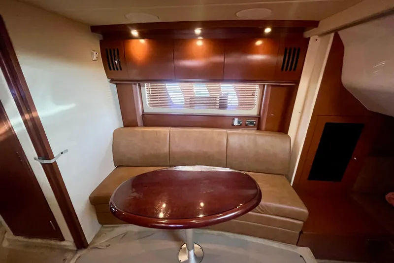  Yacht Photos Pics Luxurious interior of 2007 Sea Ray 38 Sundancer yacht with leather seating and wooden table.