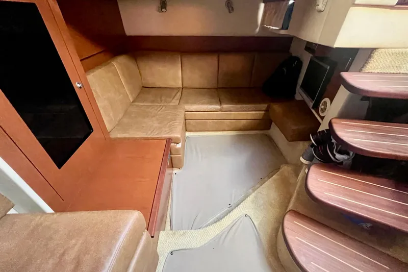  Yacht Photos Pics Interior of 2007 Sea Ray 38 Sundancer with tan leather seating and wooden steps.