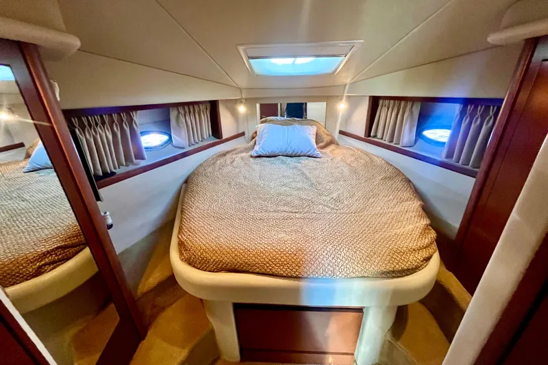  Yacht Photos Pics Luxurious cabin interior of 2007 Sea Ray 38 Sundancer yacht with cozy bedding.