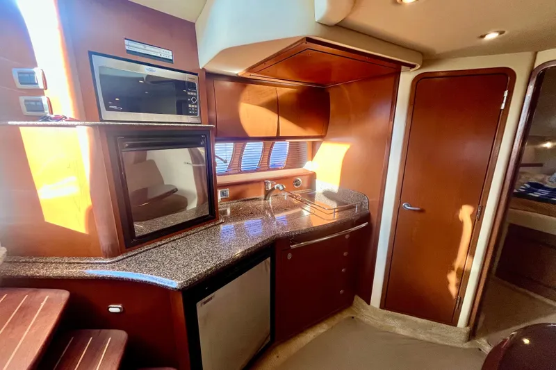  Yacht Photos Pics 2007 Sea Ray 38 Sundancer interior kitchen with wood cabinetry and modern appliances.
