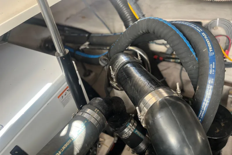  Yacht Photos Pics Engine compartment of 2007 Sea Ray 38 Sundancer with hoses and clamps visible.