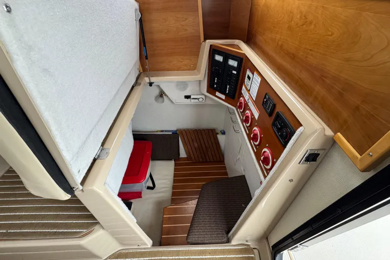  Yacht Photos Pics 2014 Cutwater 28 boat interior with control panel and wooden accents.