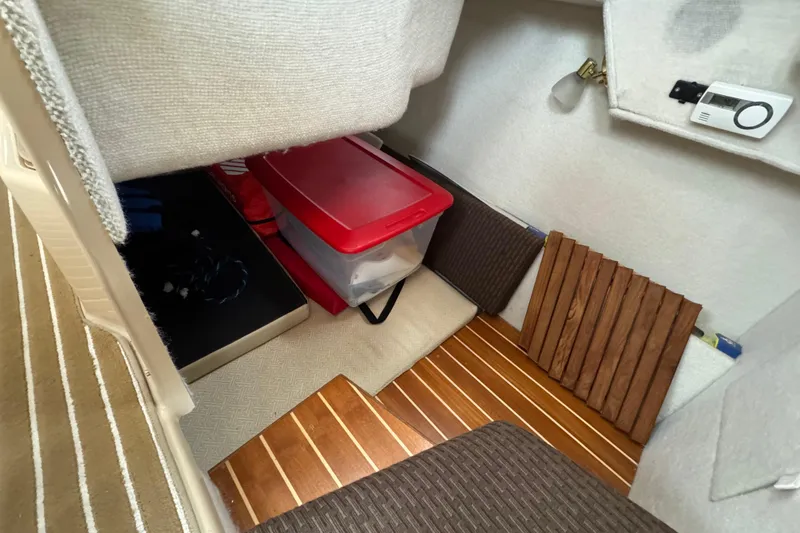  Yacht Photos Pics Interior storage area of a 2014 Cutwater 28 boat with wooden flooring.