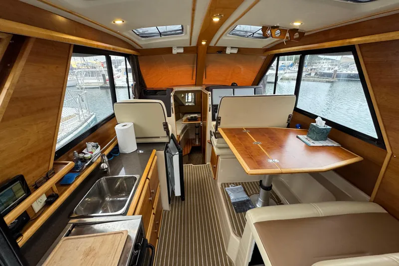  Yacht Photos Pics Interior of a 2014 Cutwater 28 boat with kitchen and dining area.