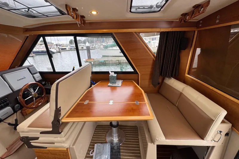  Yacht Photos Pics Interior of a 2014 Cutwater 28 boat with dining area and helm.