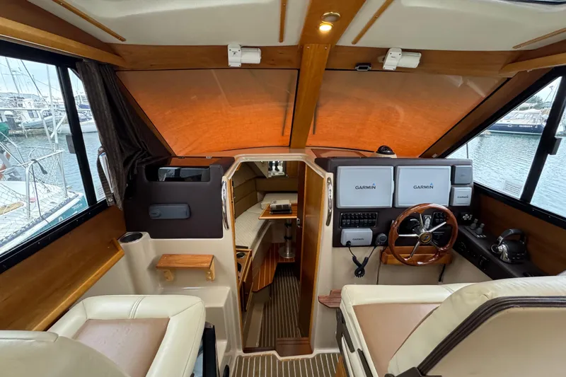 Yacht Photos Pics Interior of 2014 Cutwater 28 boat with Garmin navigation system and wooden accents.