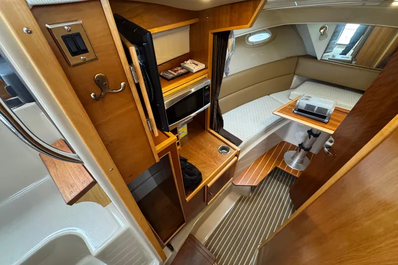  Yacht Photos Pics 2014 Cutwater 28 interior with kitchenette, seating, and sleeping area.