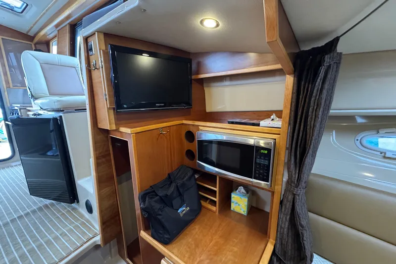  Yacht Photos Pics 2014 Cutwater 28 interior with TV, microwave, and storage space.