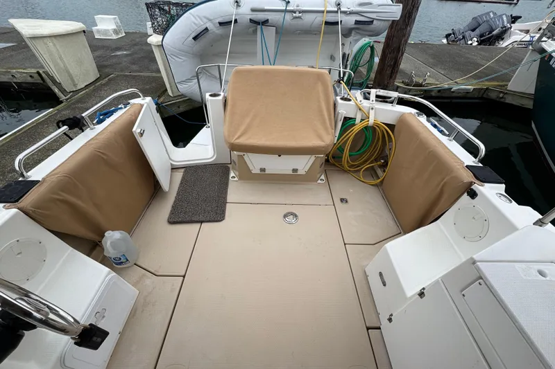  Yacht Photos Pics 2014 Cutwater 28 boat deck with tan seating, docked at marina.