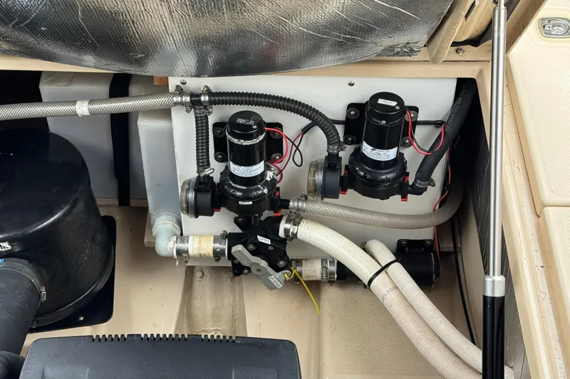  Yacht Photos Pics Engine compartment of a 2014 Cutwater 28 boat, featuring pumps and hoses.