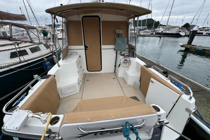  Yacht Photos Pics 2014 Cutwater 28 boat interior at marina, featuring seating and helm station.