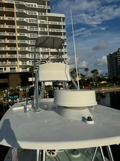  Yacht Photos Pics 2006 Regulator 32 FS boat docked near waterfront buildings under a partly cloudy sky.