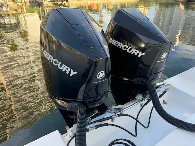  Yacht Photos Pics Twin Mercury outboard engines on a 2006 Regulator 32 FS boat, docked by the water.