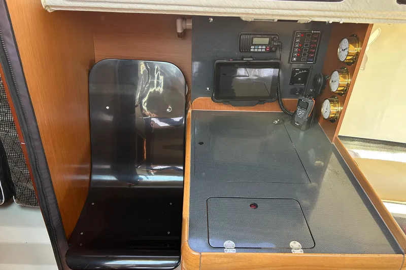  Yacht Photos Pics Interior of 2011 Jeanneau Sun Fast 3200 yacht with navigation equipment and seating area.