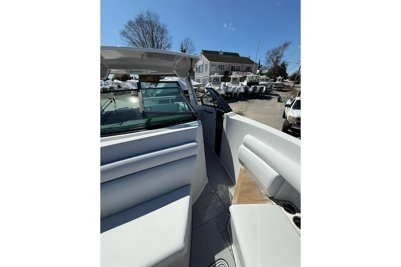 Andiamo Yacht Photos Pics 2023 Aviara AV32 I/O boat interior with seating and windshield, parked outdoors.