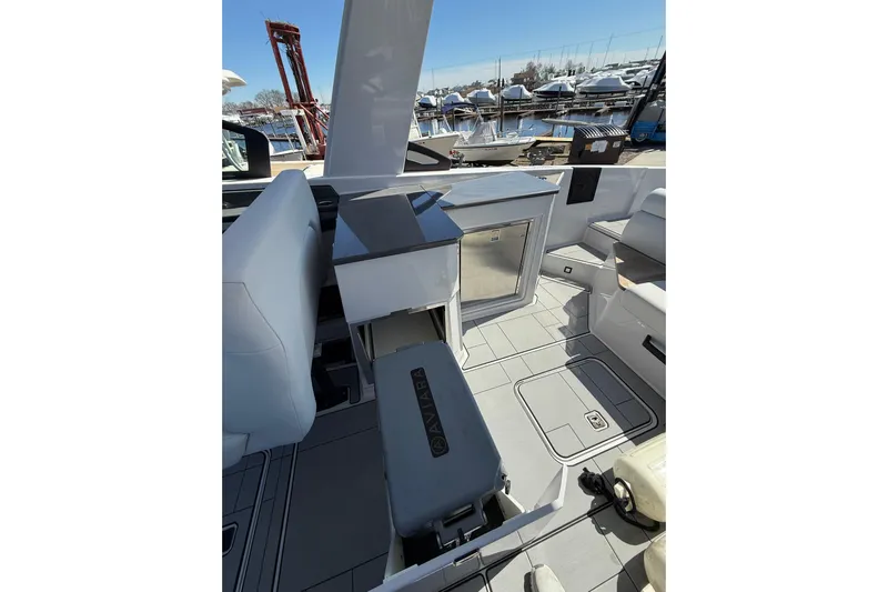 Andiamo Yacht Photos Pics 2023 Aviara AV32 I/O boat interior with seating and storage, docked at marina.