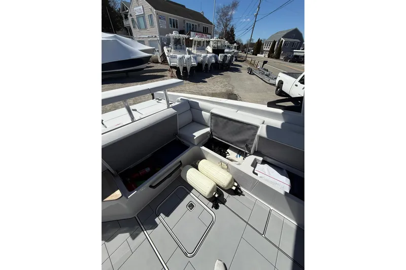 Andiamo Yacht Photos Pics 2023 Aviara AV32 I/O boat interior with open storage compartments and docked in a marina.