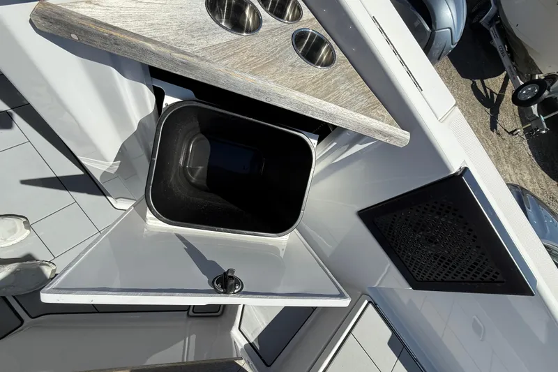 Andiamo Yacht Photos Pics 2023 Aviara AV32 I/O boat interior with storage compartment and cup holders.