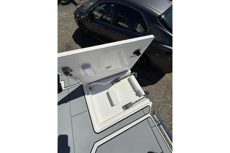 Andiamo Yacht Photos Pics Open storage compartment on 2023 Aviara AV32 I/O boat, with car in background.