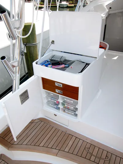 Hawk's Nest Yacht Photos Pics 2012 Shearline 34' Express boat with open storage compartment and fishing gear.