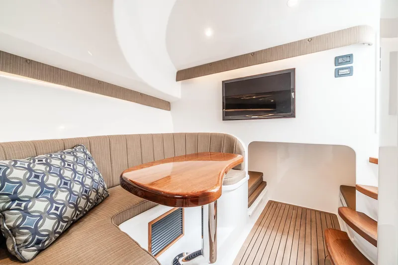 Hawk's Nest Yacht Photos Pics Interior of 2012 Shearline 34' Express yacht with wooden table and seating area.