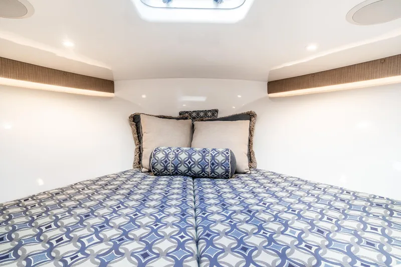 Hawk's Nest Yacht Photos Pics Luxurious cabin interior of 2012 Shearline 34' Express with patterned bedding and cushions.