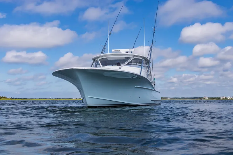 Hawk's Nest Yacht Photos Pics 2012 Shearline 34' Express boat on water under blue sky with clouds.