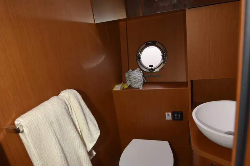  Yacht Photos Pics Bathroom interior of 2023 Beneteau Swift Trawler 41 Fly with wooden finish.