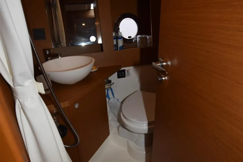  Yacht Photos Pics Bathroom interior of 2023 Beneteau Swift Trawler 41 Fly, featuring modern sink and toilet.