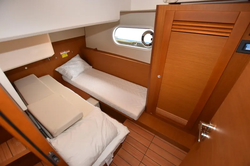  Yacht Photos Pics 2023 Beneteau Swift Trawler 41 Fly cabin with wooden interior and twin beds.